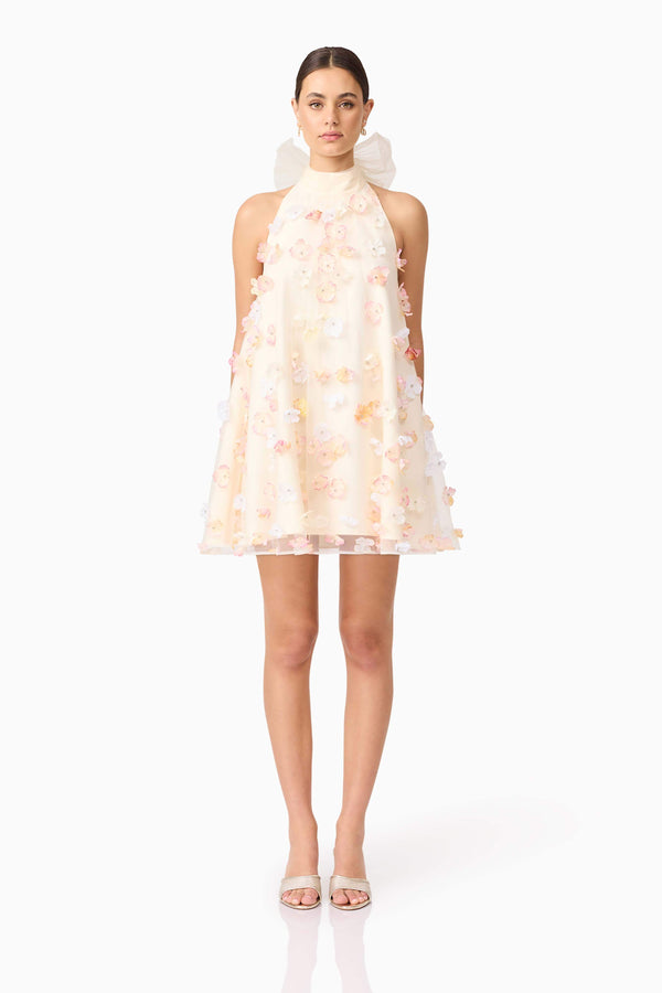 Brunette model wears Livia Trapeze Mini Dress in White front view