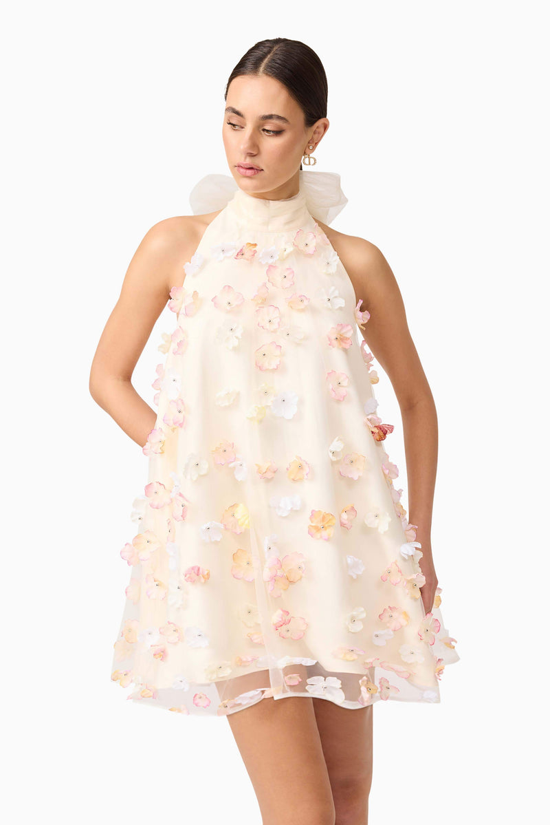 Brunette model wears Livia Trapeze Mini Dress in White front close up