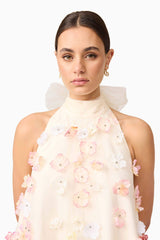 Brunette model wears Livia Trapeze Mini Dress in White top half close up