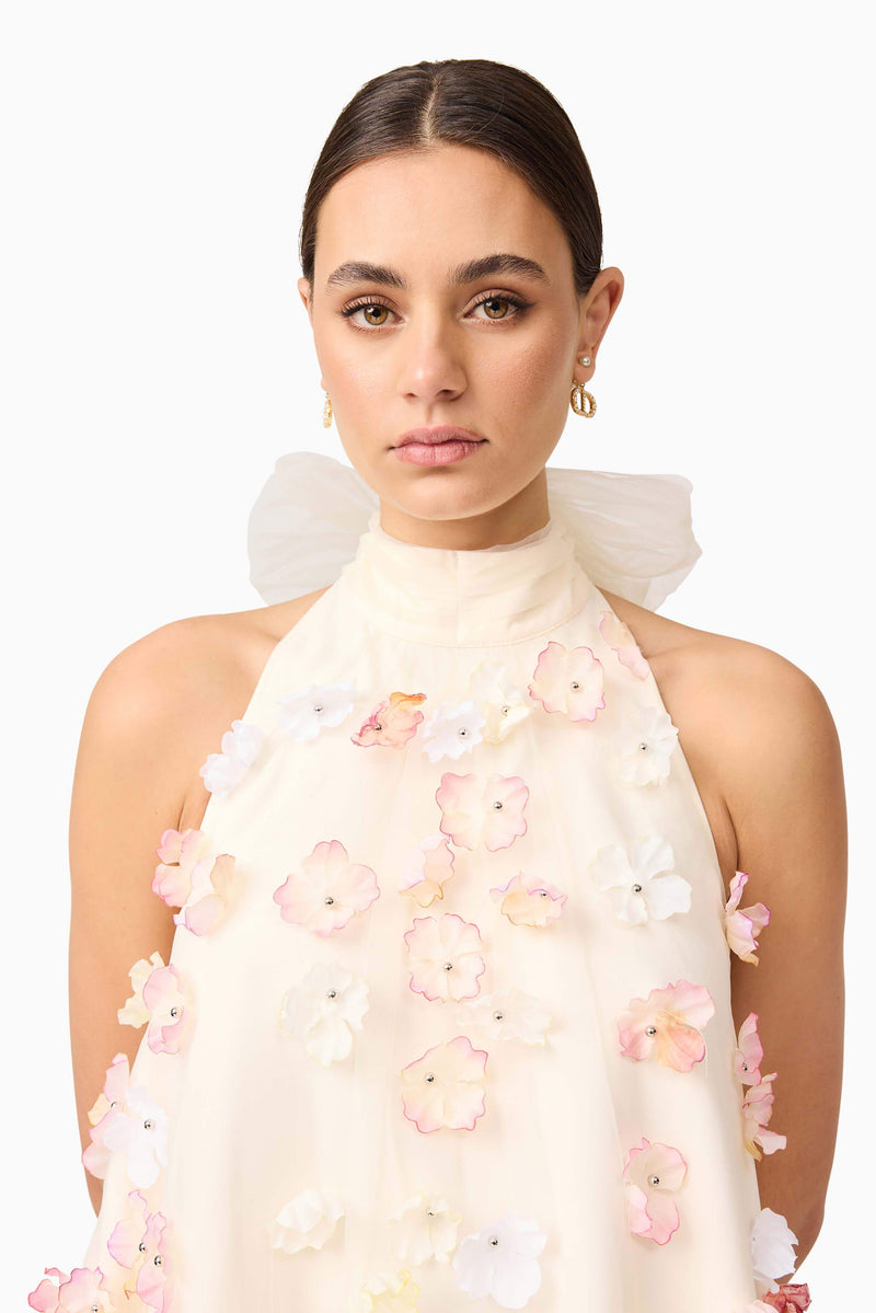 Brunette model wears Livia Trapeze Mini Dress in White top half close up