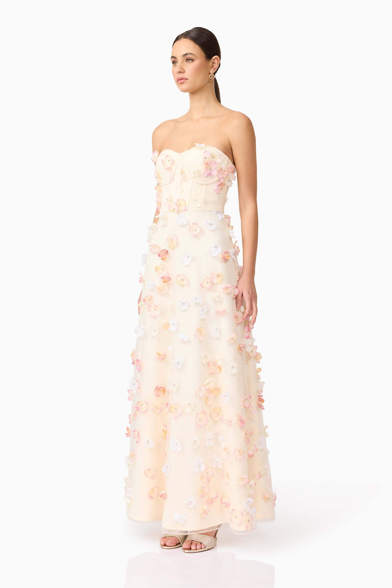 Brunette model wears Livia Maxi Dress in White side view
