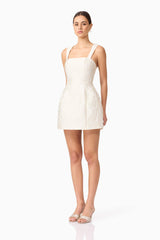 Brunette model wearing Galadirel Mini Dress in White side shot