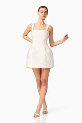 Brunette model wearing Galadirel Mini Dress in White posed shot