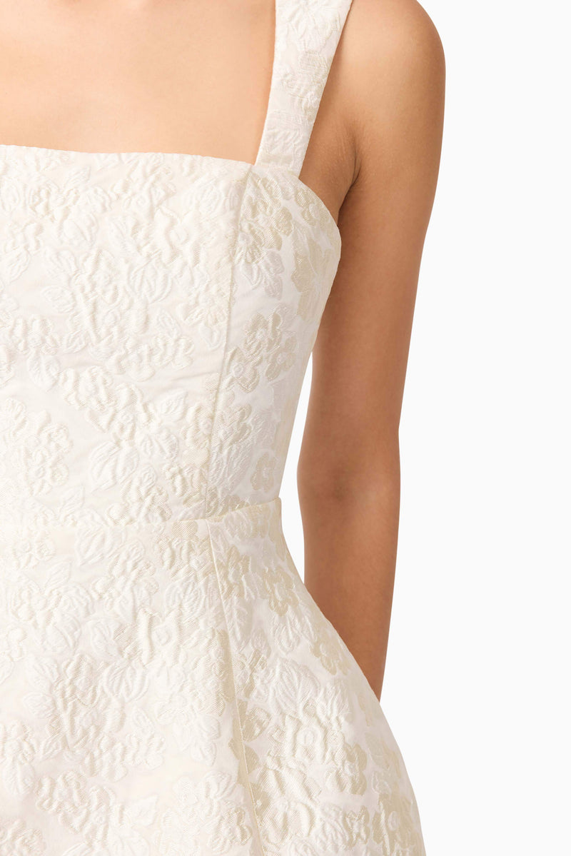 Brunette model wearing Galadirel Mini Dress in White detail shot