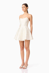 Brunette model wearing Galadirel Strapless Mini Dress in White side shot