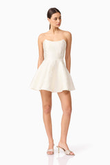 Brunette model wearing Galadirel Strapless Mini Dress in White posed shot