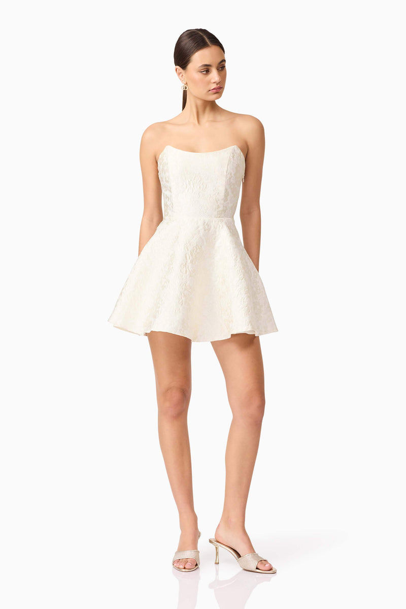 Brunette model wearing Galadirel Strapless Mini Dress in White posed shot