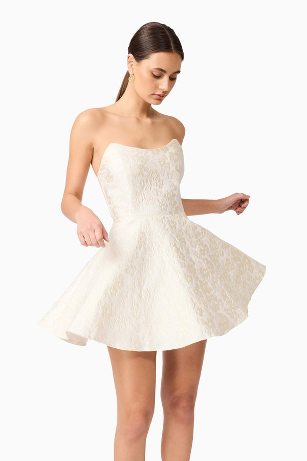 Brunette model wearing Galadirel Strapless Mini Dress in White close up posedshot