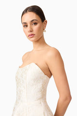 Brunette model wearing Galadirel Strapless Mini Dress in White close up shot