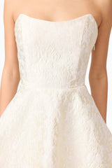 Brunette model wearing Galadirel Strapless Mini Dress in White detail shot