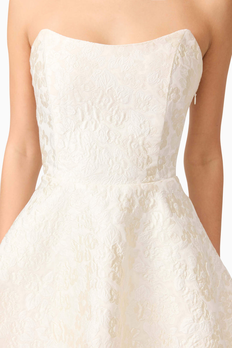 Brunette model wearing Galadirel Strapless Mini Dress in White detail shot