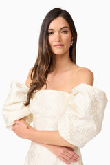 Brunette model wearing Galadirel Puff Sleeve Midi Dress in White close up shot