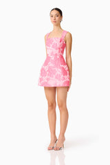 Brunette model wearing the Dionne Tulip Mini Dress in Pink Floral side shot