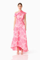Brunette model wearing the Dionne Asymmetrical Maxi Gown in Pink Floral front shot