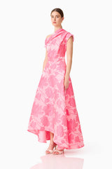 Brunette model wearing the Dionne Asymmetrical Maxi Gown in Pink Floral side shot