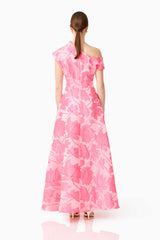 Brunette model wearing the Dionne Asymmetrical Maxi Gown in Pink Floral Back shot
