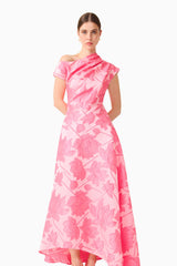 Brunette model wearing the Dionne Asymmetrical Maxi Gown in Pink Floral posed shot