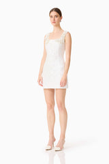 Brunette model wearing the Alessia Embellished Mini Dress in White side shot