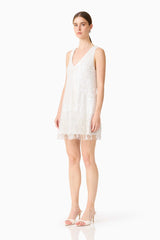 Brunette model wearing Alessia Embellished Shift Mini Dress in White side shot 