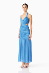 Brunette model wearing the Elena Halter Gown in Blue side shot