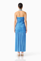 Brunette model wearing the Elena Halter Gown in Blue back shot
