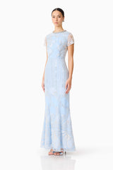 Brunette model wearing the Annabelle Embellished Gown in Blue side shot 