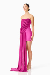 Brunette model wearing the Chantal Asymmetrical Mini Dress in Pink side shot 