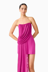 Brunette model wearing the Chantal Asymmetrical Mini Dress in Pink posed shot 