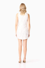 Blonde model wearing Elara Shift Dress in White back shot