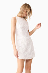 Blonde model wearing Elara Shift Dress in White close up shot