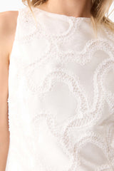 Blonde model wearing Elara Shift Dress in White detail shot 