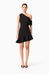 Brunette model wearing Ava Asymmetrical Mini Dress in Black front shot