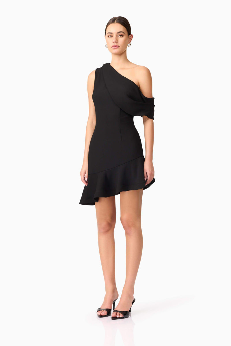 Brunette model wearing Ava Asymmetrical Mini Dress in Black side shot