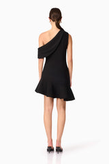 Brunette model wearing Ava Asymmetrical Mini Dress in Black back shot