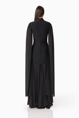 Brunette model wearing the Odelia Cape Sleeve Gown in Black back shot