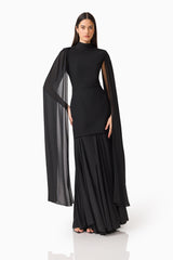 Brunette model wearing the Odelia Cape Sleeve Gown in Black hand on hip shot