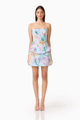 Brunette model wearing the Priselle Peplum Top & Mini Skirt Set in Blue Floral front shot