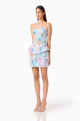 Brunette model wearing the Priselle Peplum Top & Mini Skirt Set in Blue Floral side shot