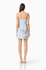 Brunette model wearing the Priselle Peplum Top & Mini Skirt Set in Blue Floral back shot