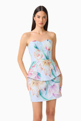 Brunette model wearing the Priselle Peplum Top & Mini Skirt Set in Blue Floral close up shot