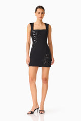 Brunette model wears the Odelia Beaded Mini Dress in Black posed shot