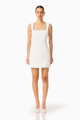 Brunette woman wearing the Odelia Beaded Mini Dress in White front shot