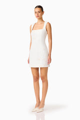 Brunette woman wearing the Odelia Beaded Mini Dress in White, side shot