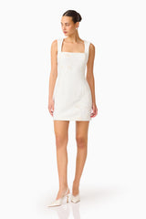 Brunette woman wearing the Odelia Beaded Mini Dress in White, posed shot looking slightly to side