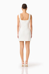 Brunette woman wearing the Odelia Beaded Mini Dress in White, back shot