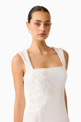 Brunette woman wearing the Odelia Beaded Mini Dress in White, closeup of her face and the embellished detail