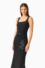 Brunette model wearing the Odelia Beaded Maxi Dress in Black side close up shot