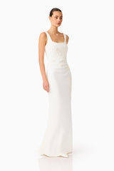 Brunette model wearing the Odelia Beaded Maxi Dress in White side looking away shot