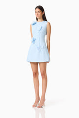 Brunette model wearing the Reina Applique Mini Dress in Sky Blue side shot