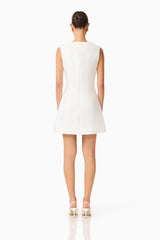Brunette model wearing the Reina Applique Mini Dress Dress White back shot